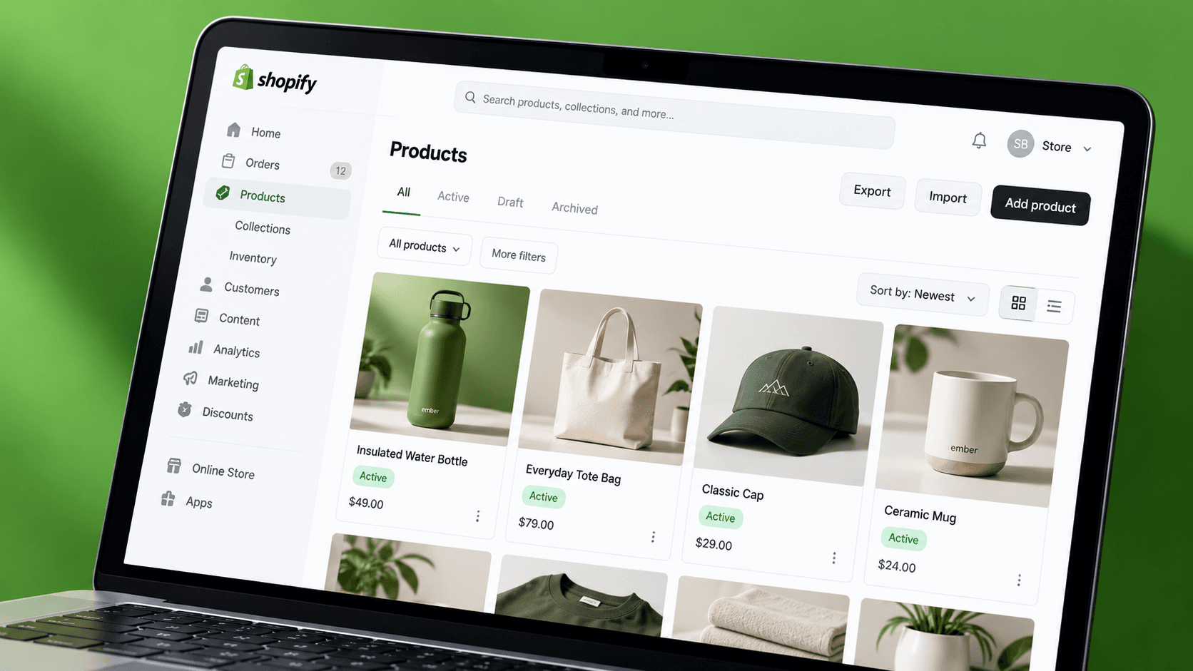 A laptop showing a Shopify products dashboard with product cards for a water bottle, tote bag, cap and mug