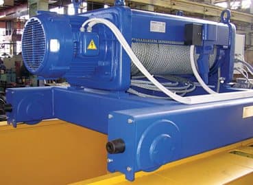 Blue electric wire rope hoist mounted on a crane girder