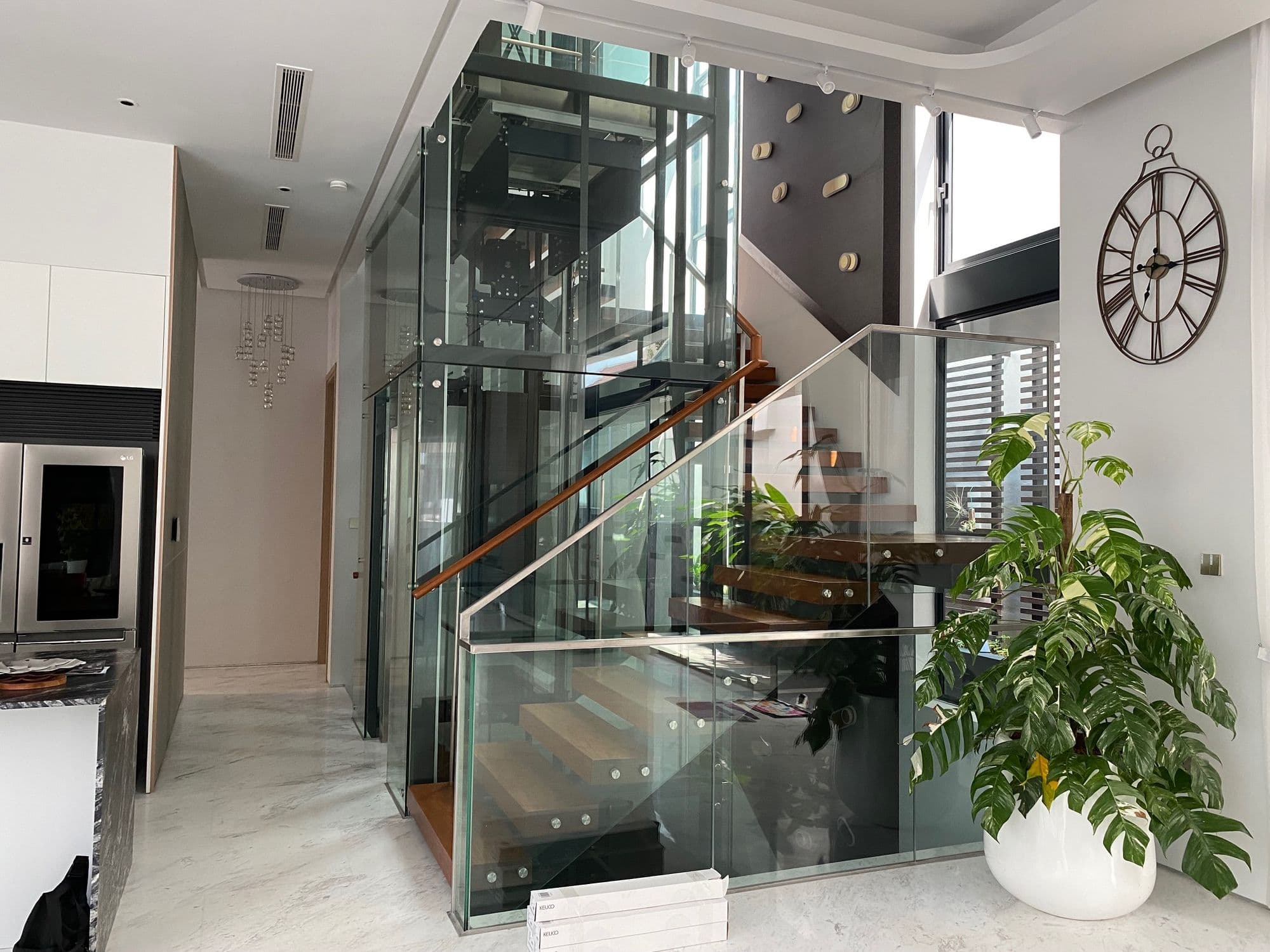 Glass lift and staircase inside a residence
